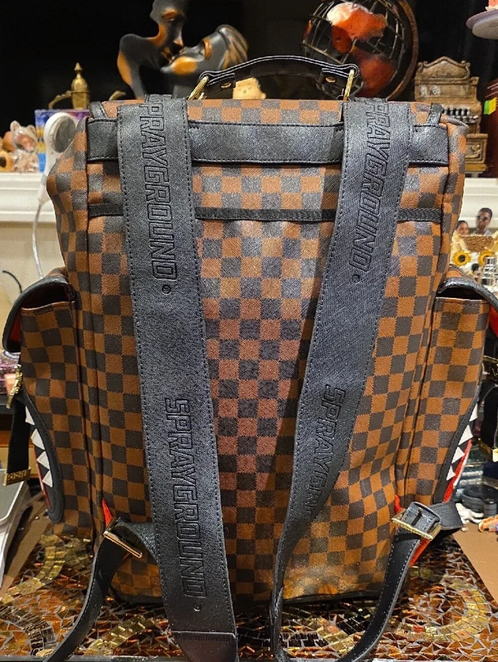 Sprayground Brown Checkerboard Backpack with Black Trim and Red Accent